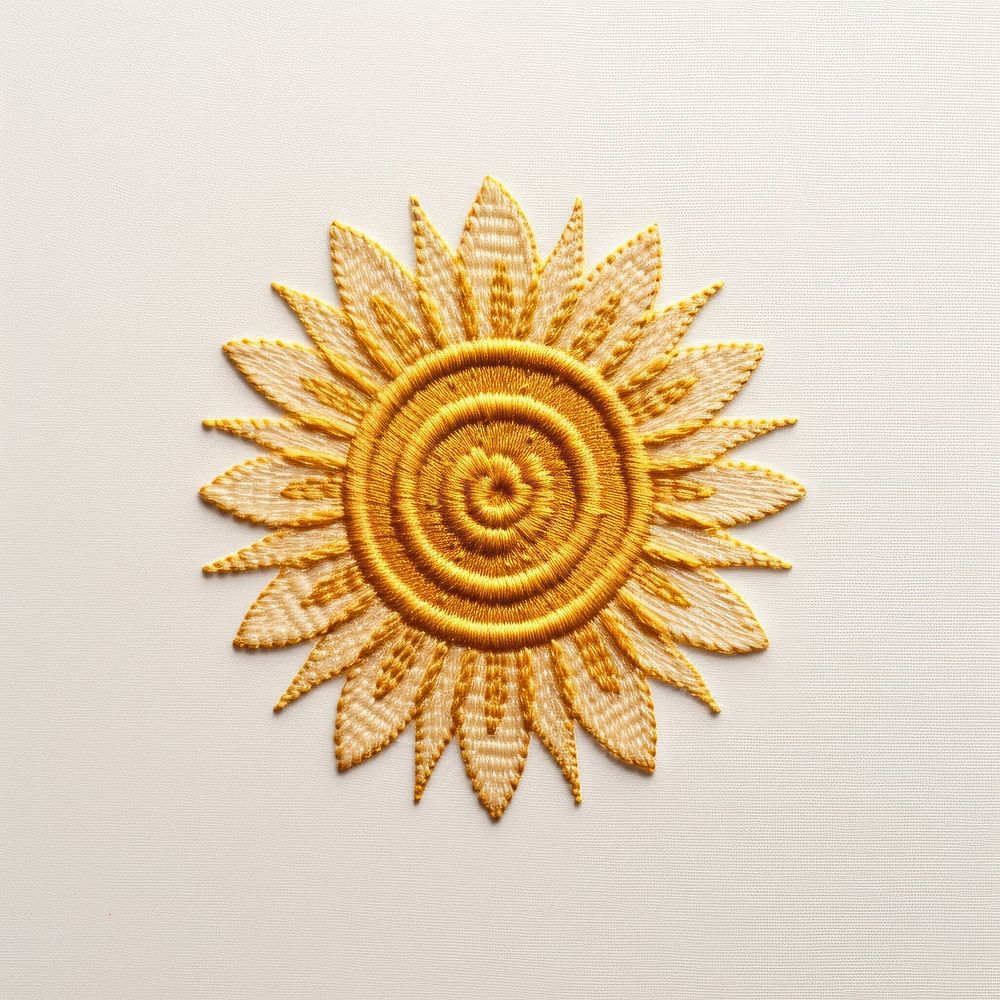 A sun in embroidery style pattern brooch gold.