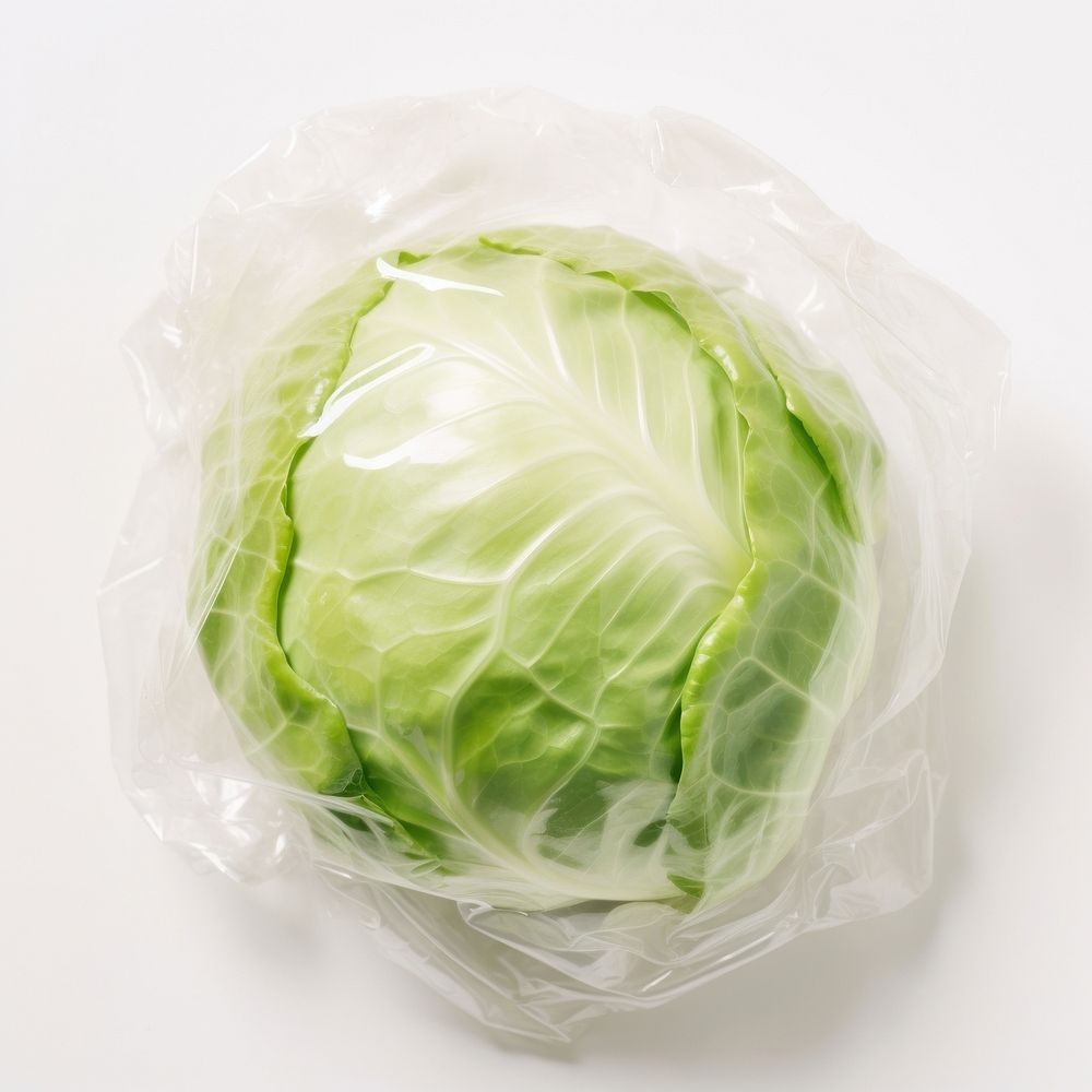 Plastic wrapping over a cabbage vegetable plant food.