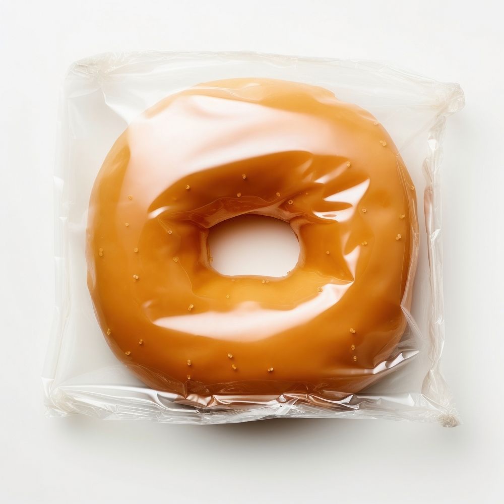 Plastic wrapping over a donut dessert bagel food.