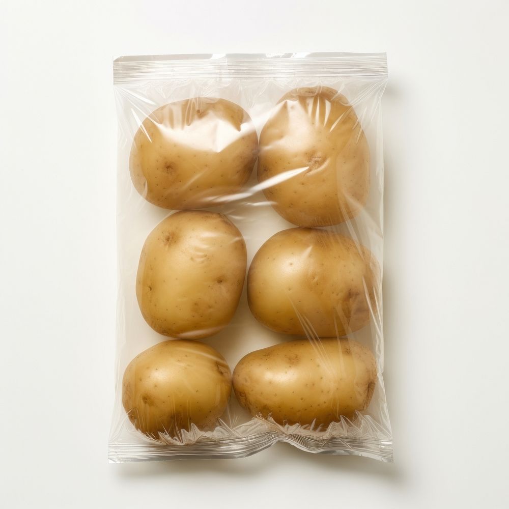 Plastic wrapping over a potato vegetable food white background.