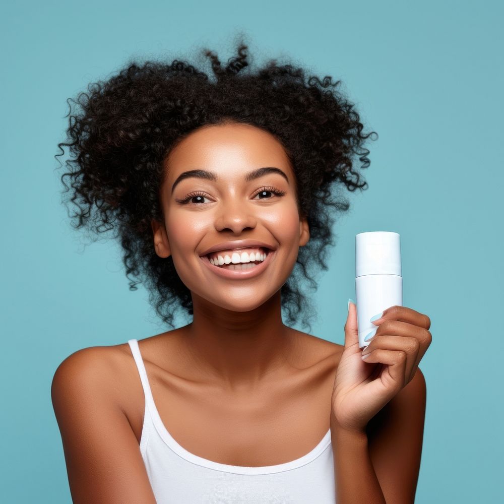 Happy woman bited a white cosmetic cream tube portrait adult smile.