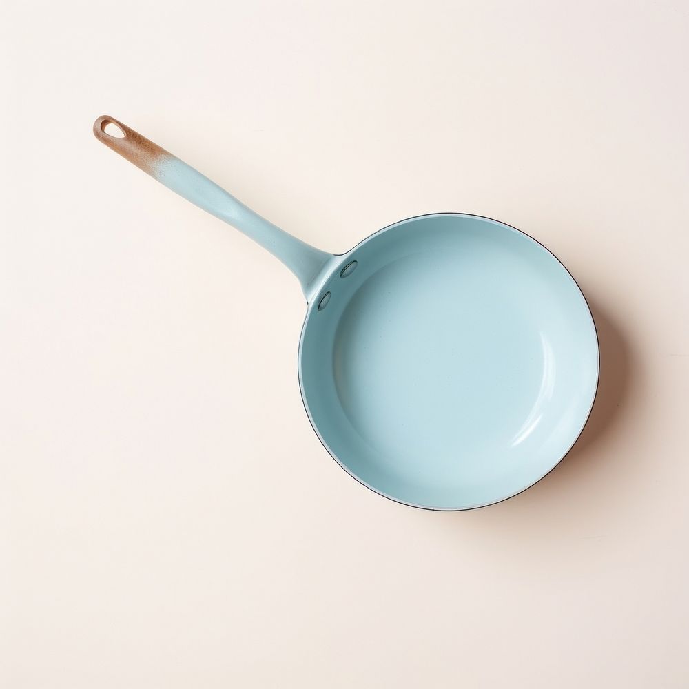 A babyblue ceramic pan cookware white background simplicity.