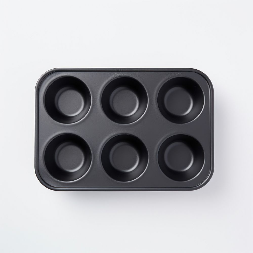 A black muffin pan white background electronics multimedia.
