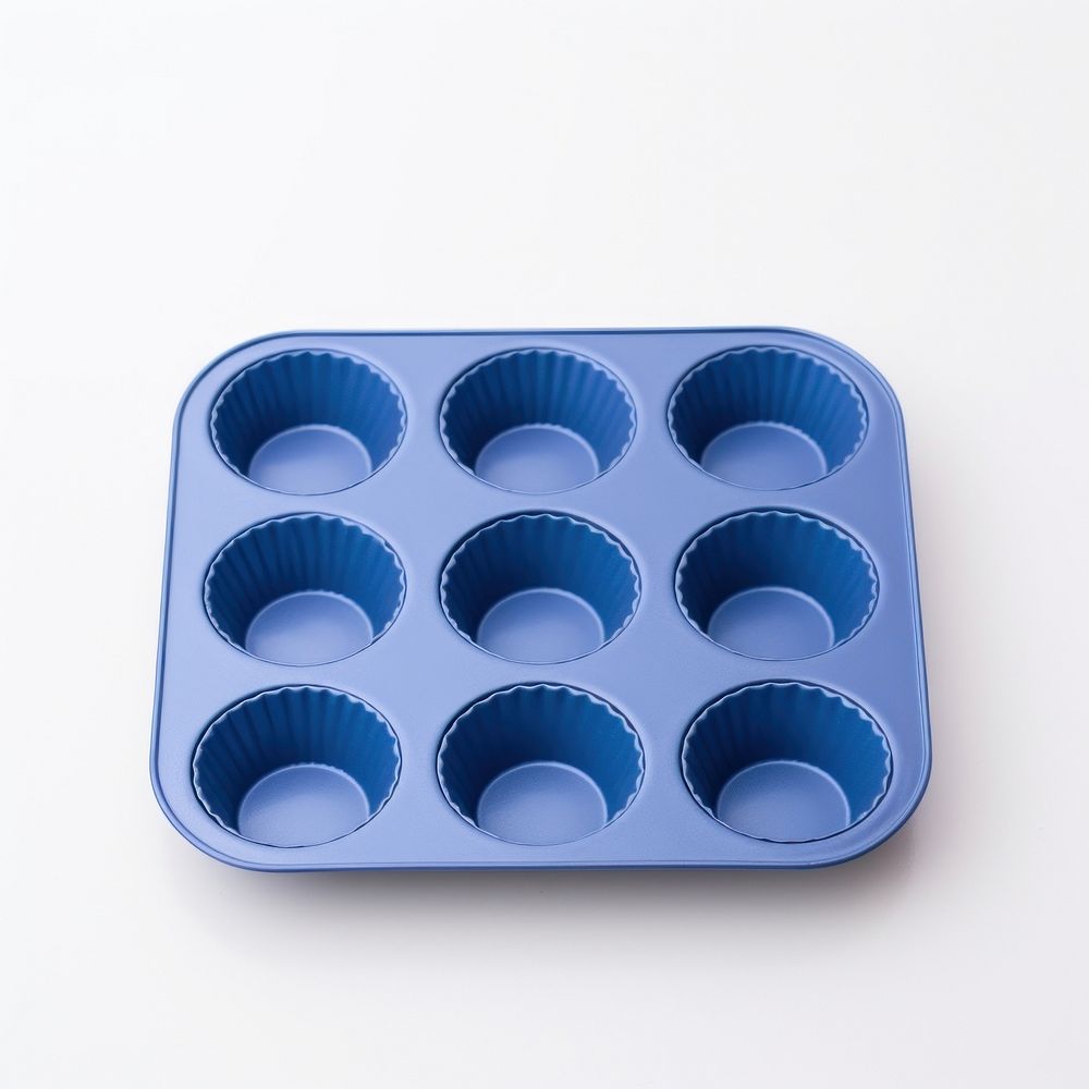 A blue muffin pan white background medication chocolate.