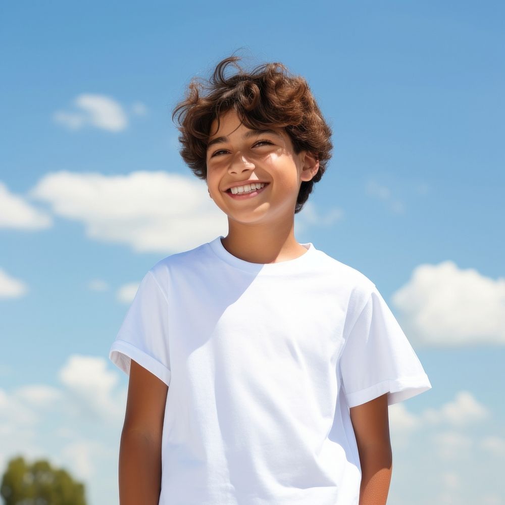 Boy wearing white t-shirt outdoors smiling smile.