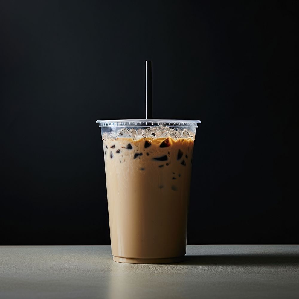 A plastic disposable ice coffee glass with straw and blank white label drink cup refreshment.