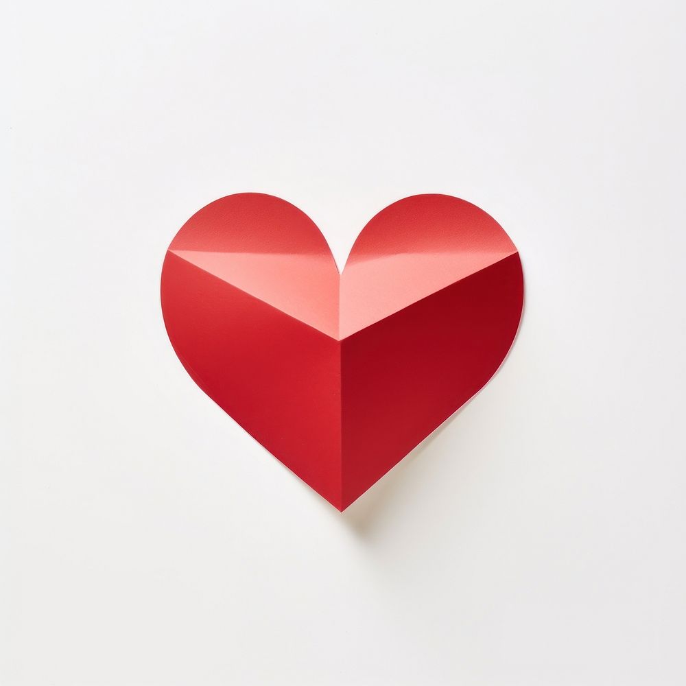 Red heart cut out from a piece of paper symbol white background creativity.