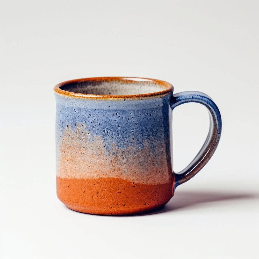 A minimal two tone colored of orange and blue coffee mug pottery porcelain drink.