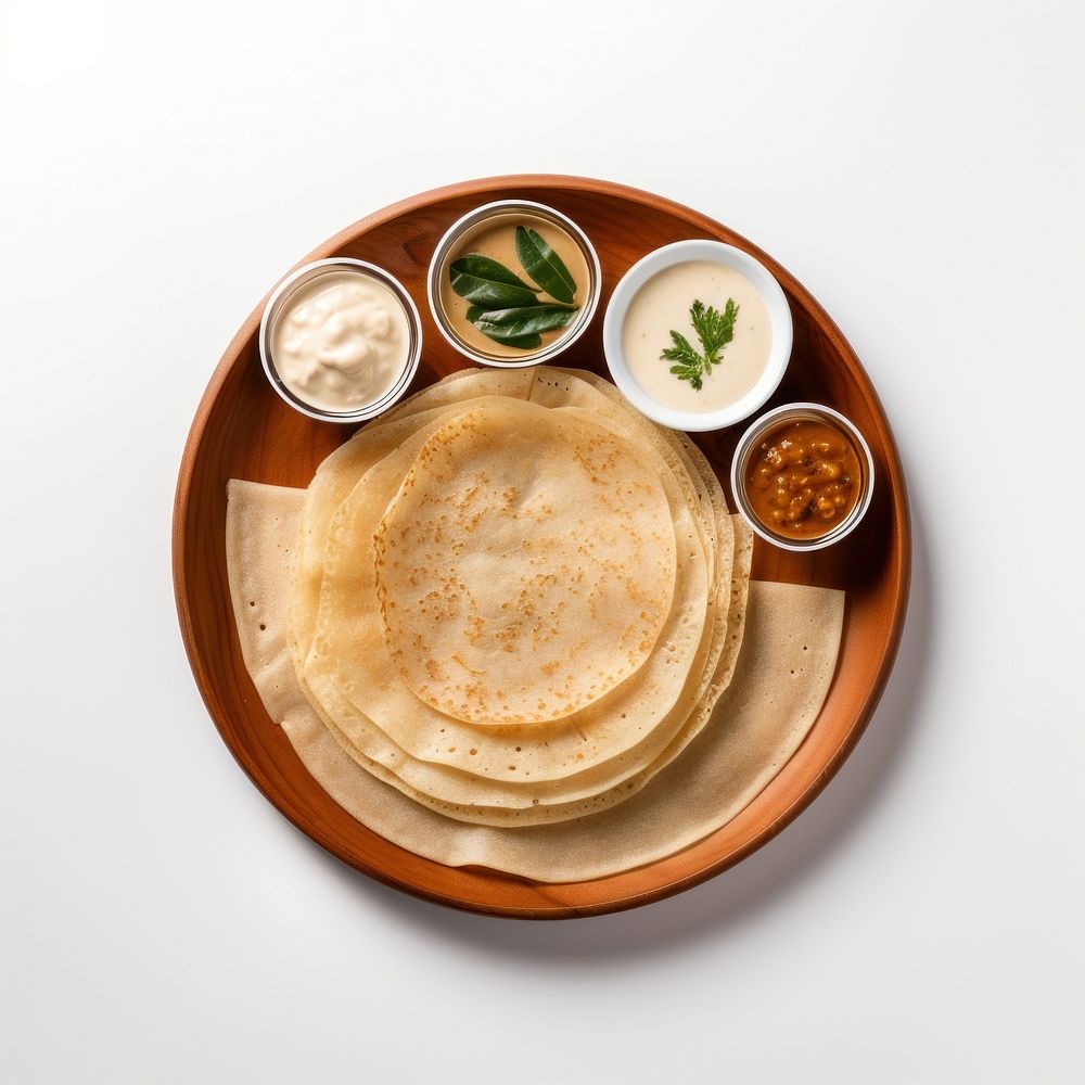 A White beige minimalistic photography of Dosas in cook book style pancake bread plate.