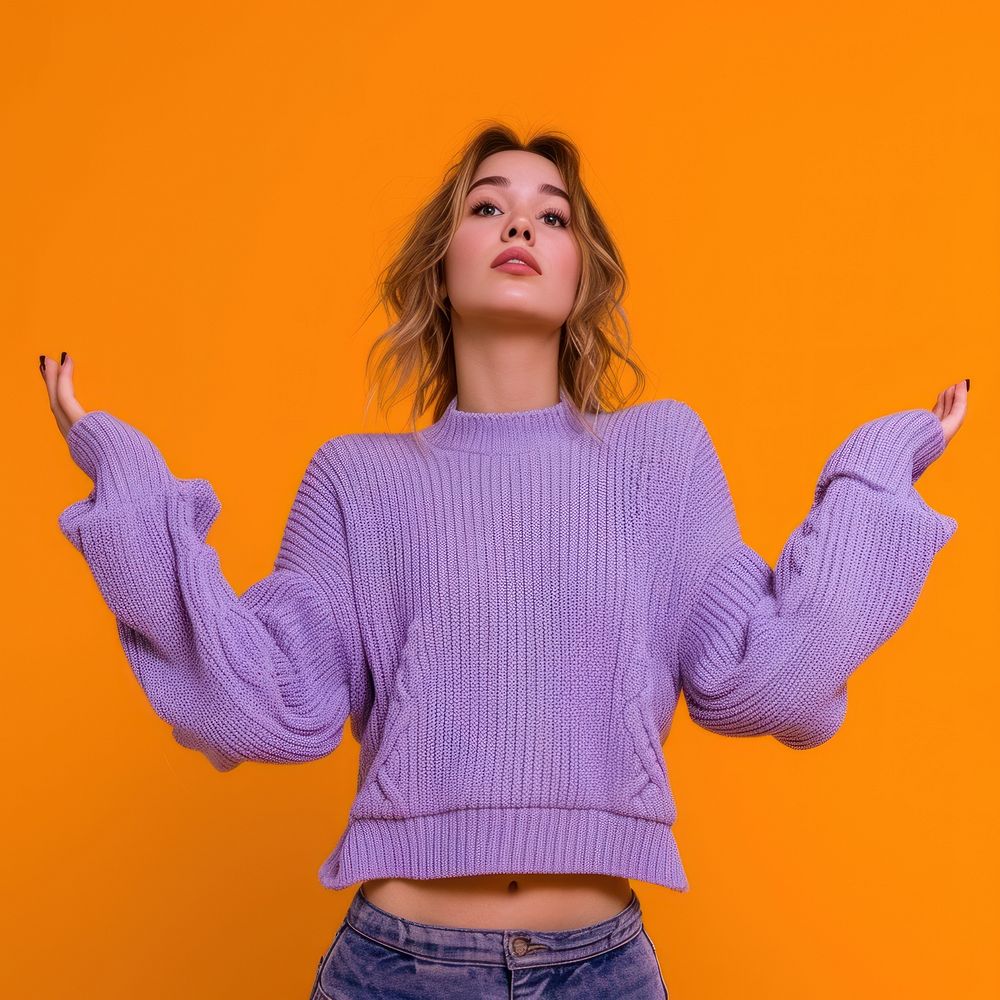 Woman in purple sweater with her arms open sweatshirt hairstyle gesturing.