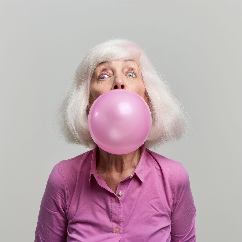 Woman blows off a pink bubble wig portrait balloon adult.