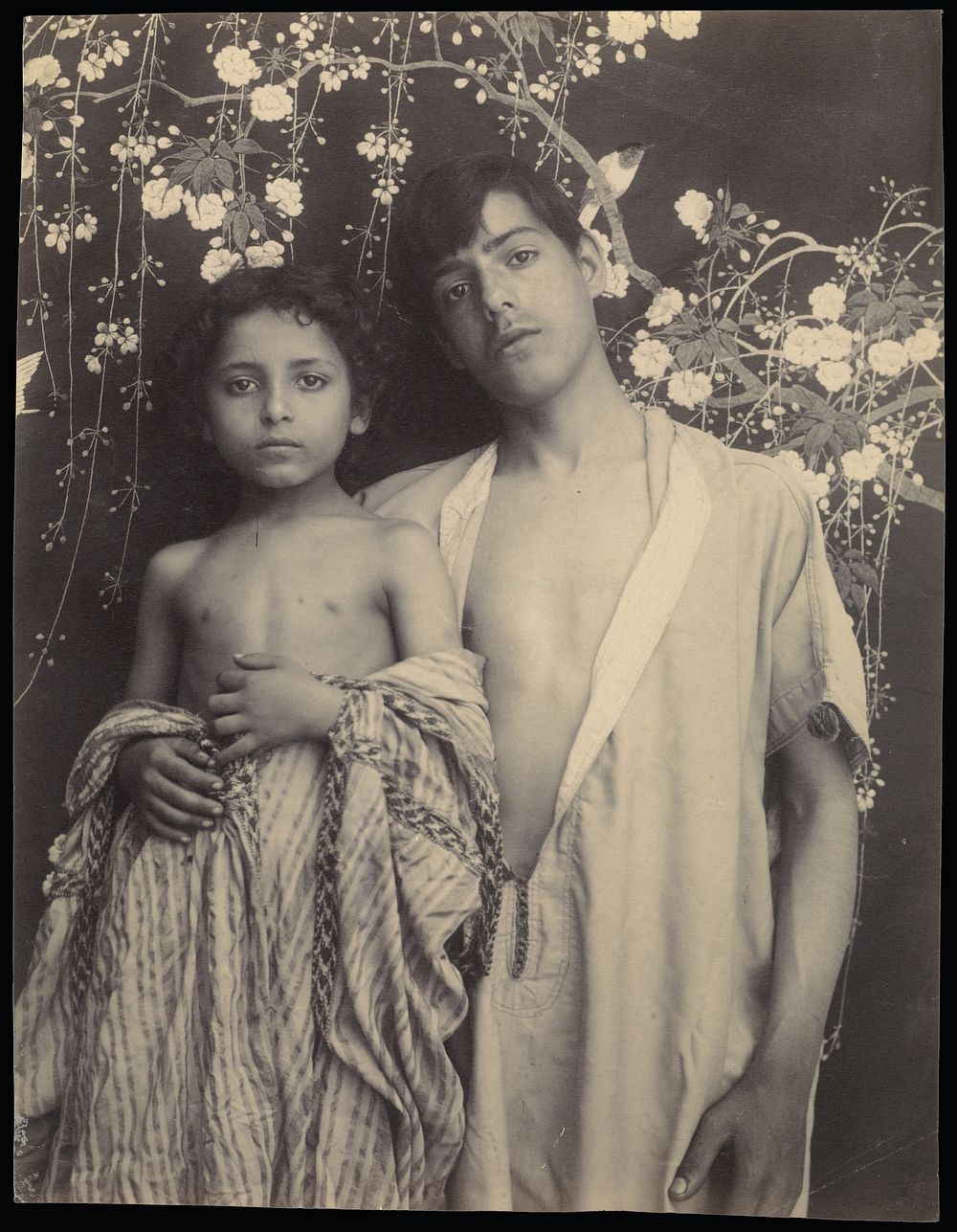 Sicilian Boy and Girl Before Floral Textile by Baron Wilhelm von Gloeden