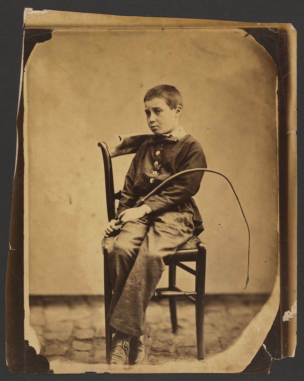 Boy holding a whip