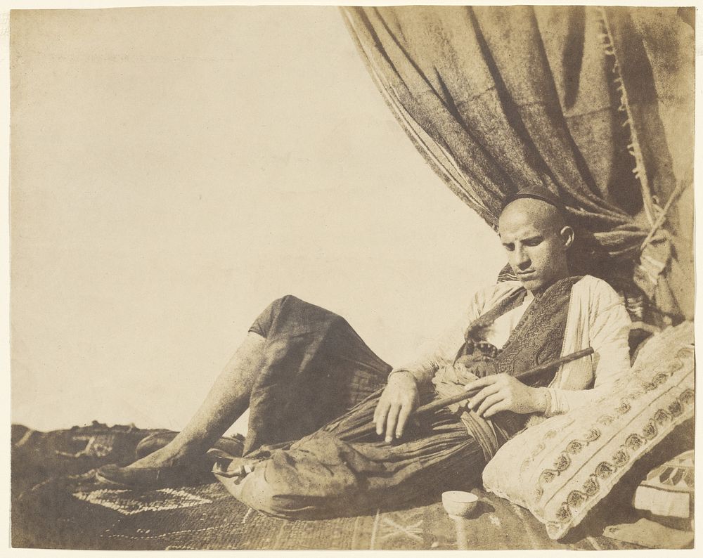 Reclining Algerian man with pipe