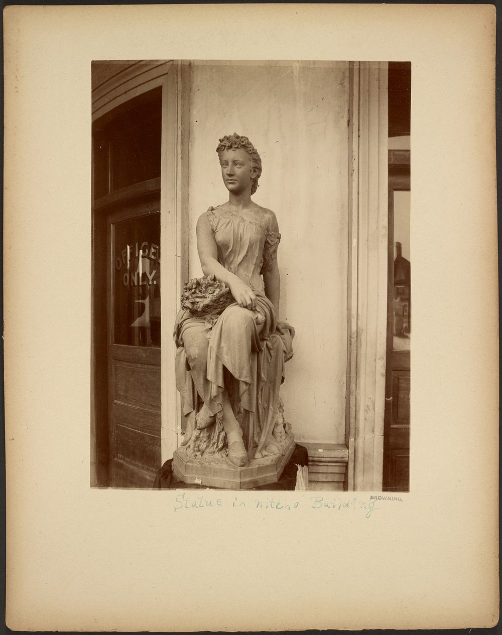 Statue in niche of Building by Browning