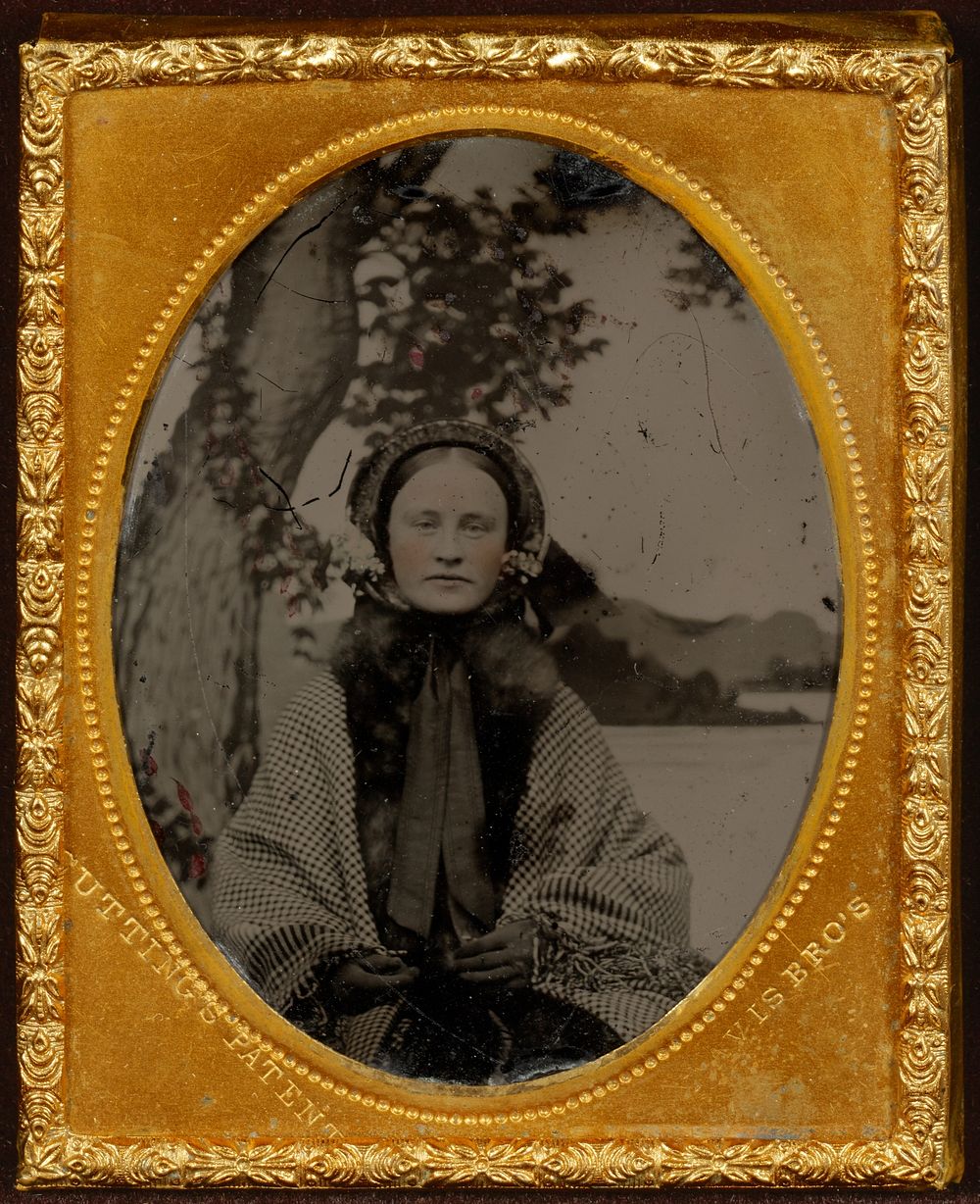 Portrait of a young woman wearing a bonnet, shawl, and gloves by Davis Brothers