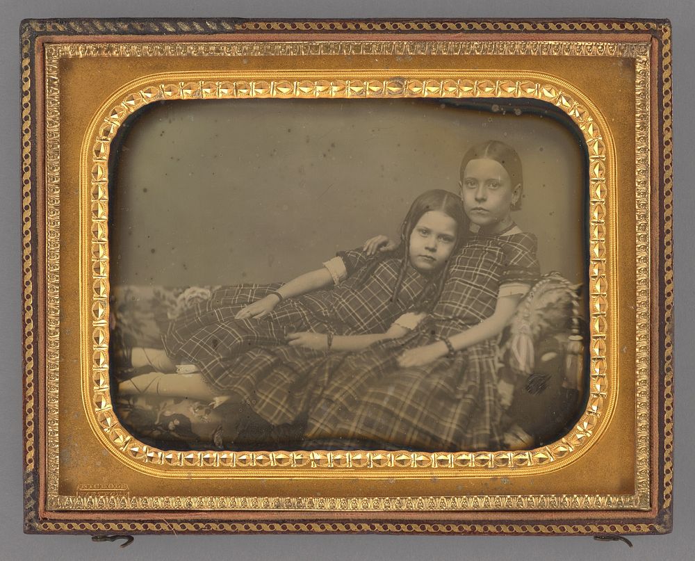 Portrait of two girls reclining on chaise lounge by Sheldon K Nichols