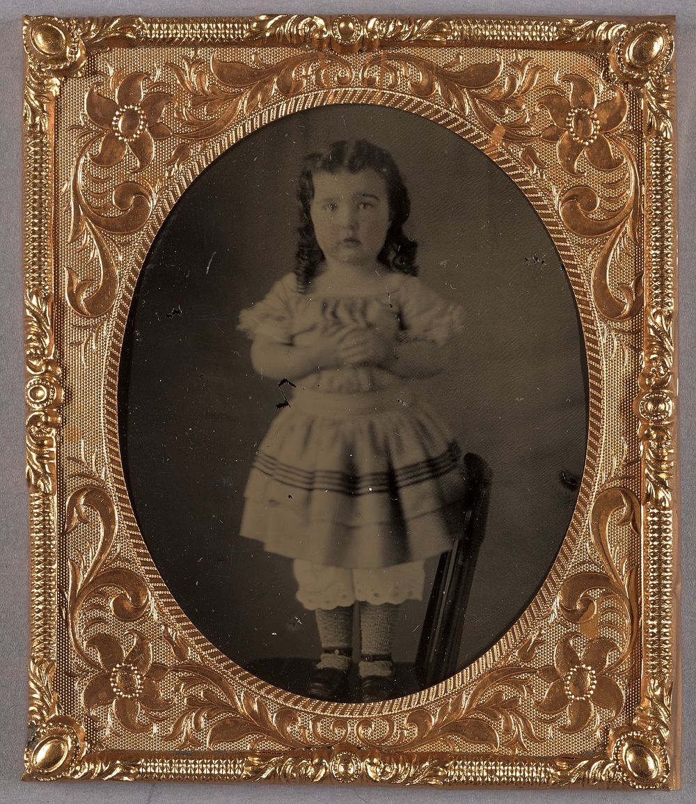 Portrait of a Little Girl Standing on a Chair