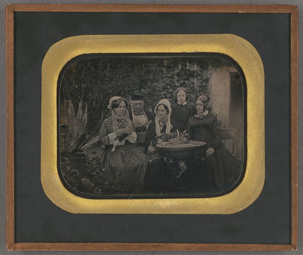 Group portrait of five people in a garden