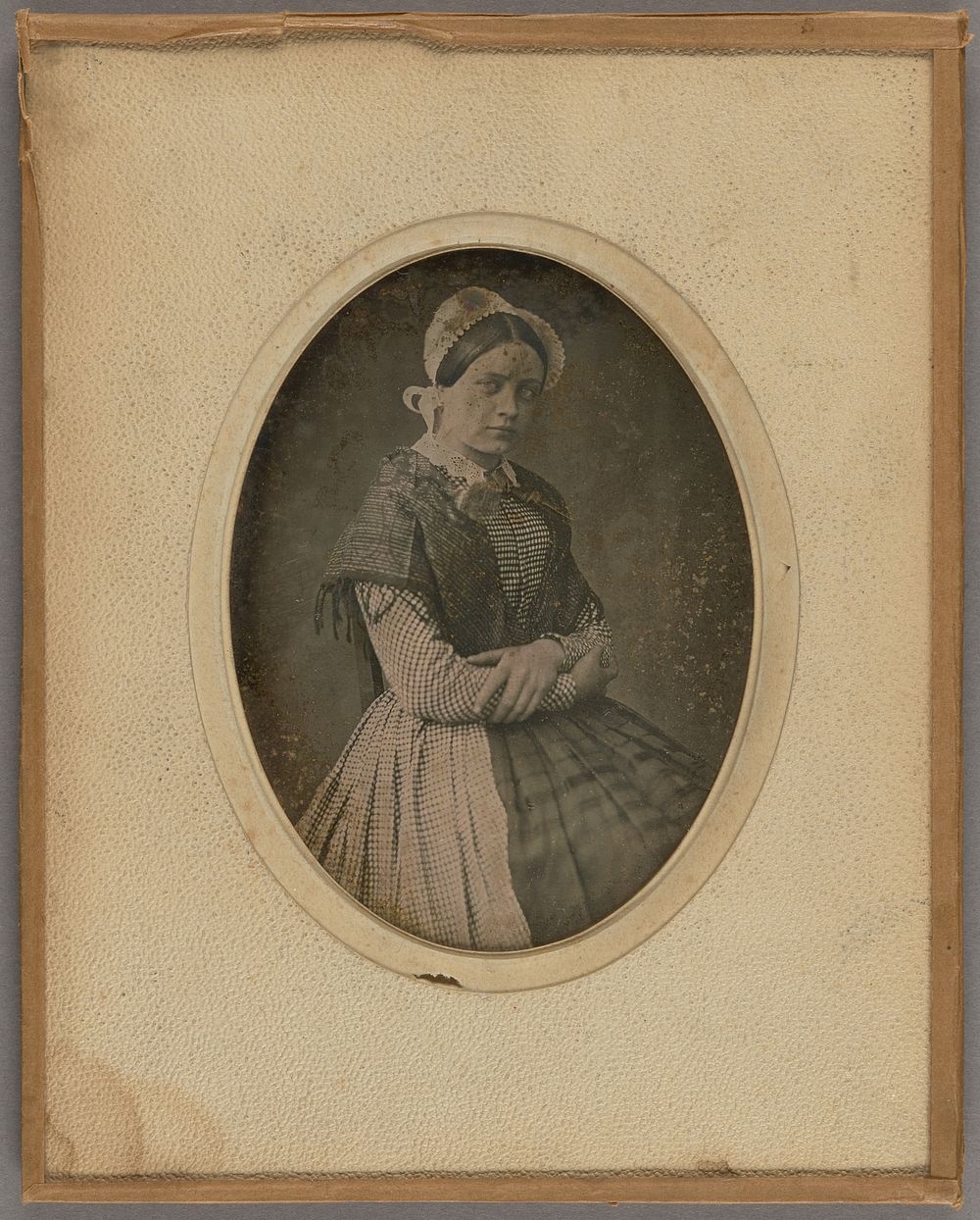Portrait of a young woman wearing a bonnet by Dubois