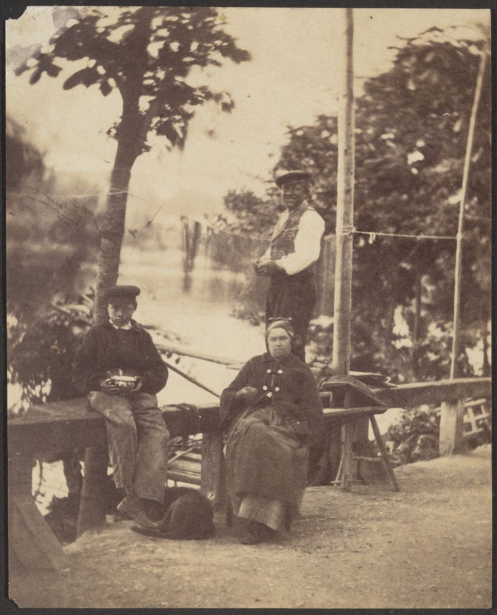 Three People along a River Bank