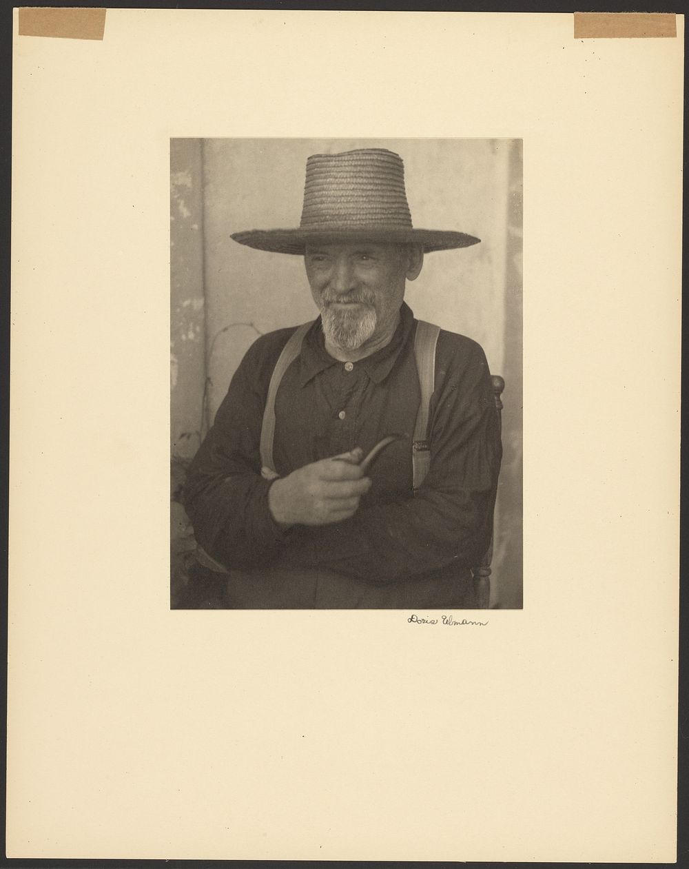 Bearded Man in a Straw Hat Holding a Pipe by Doris Ulmann