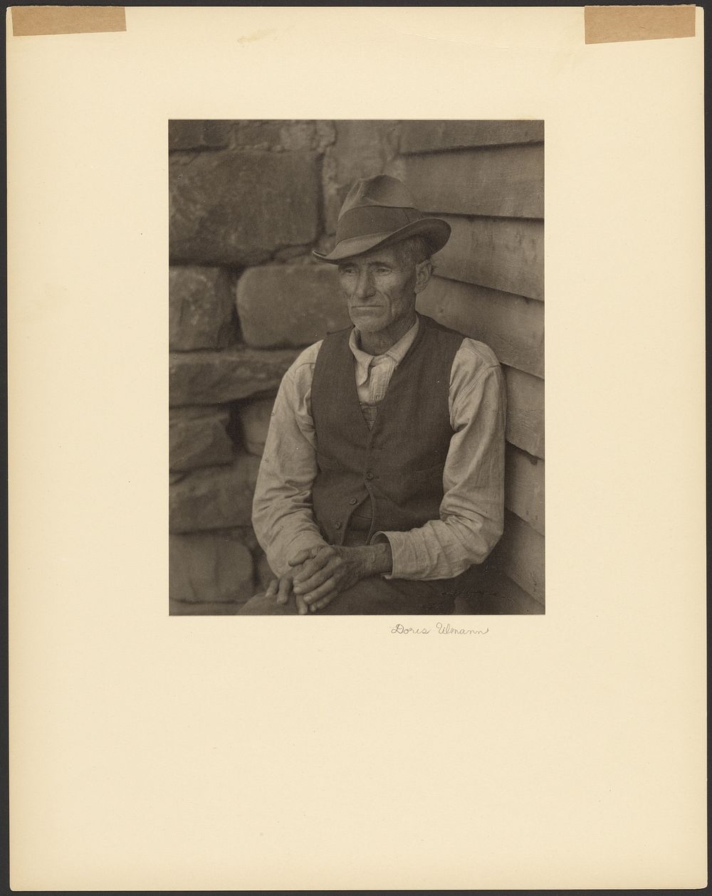 Man in Vest and Felt Hat Standing by Corner of Building by Doris Ulmann