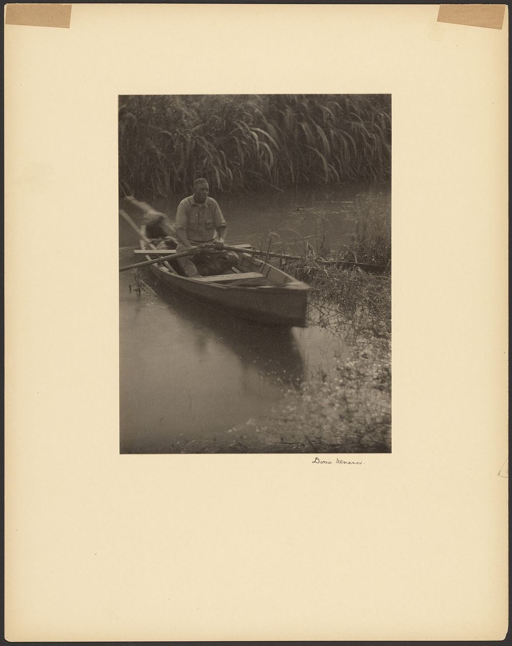 Black Man Rowing a Small Boat by Doris Ulmann
