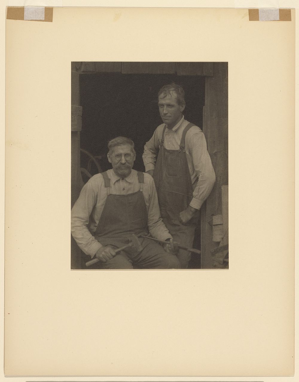 Two Men in Overalls in Doorway of a Barn by Doris Ulmann