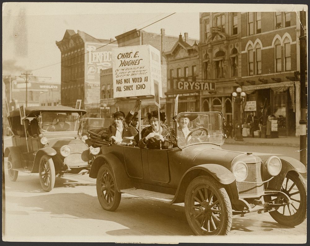 Women in car with Hughes campaign poster by Underwood and Underwood