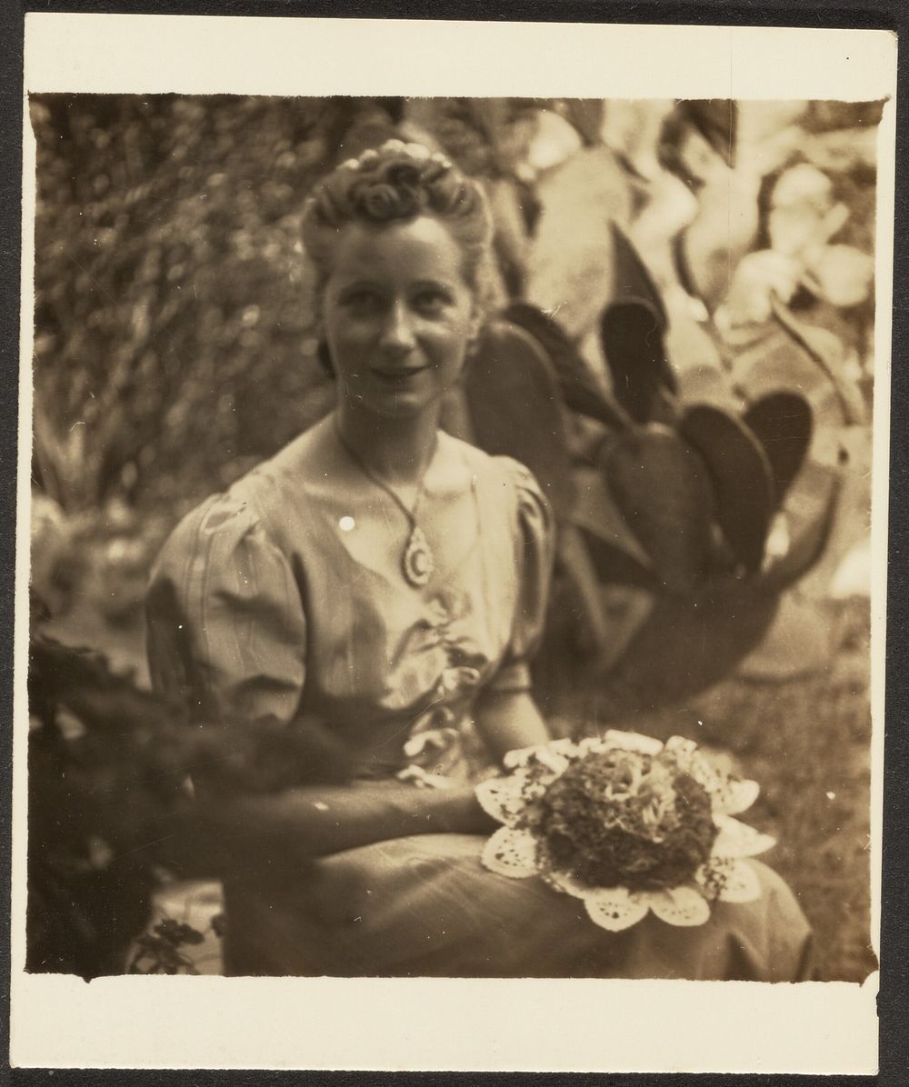 Woman Holding Bouquet Sitting before Cactus by Louis Fleckenstein