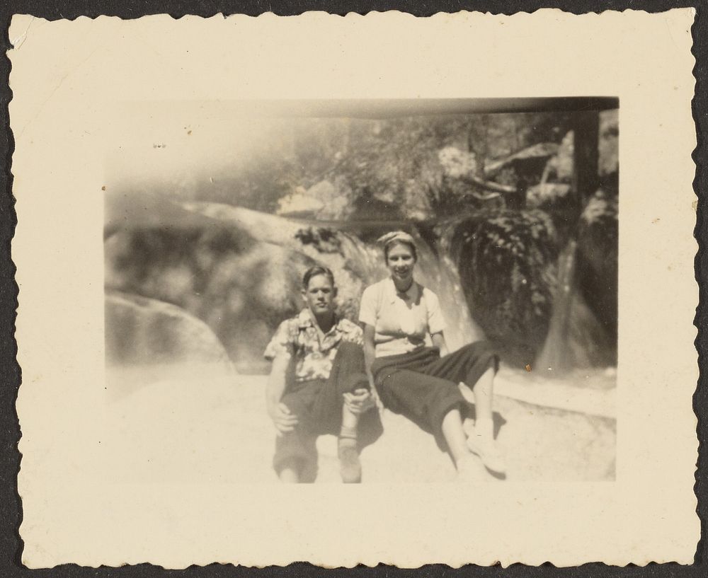 Man and Woman Sitting on Large Rock by Louis Fleckenstein