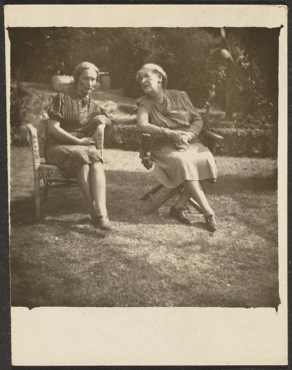 Two Women Seated in Lawn Chairs by Louis Fleckenstein