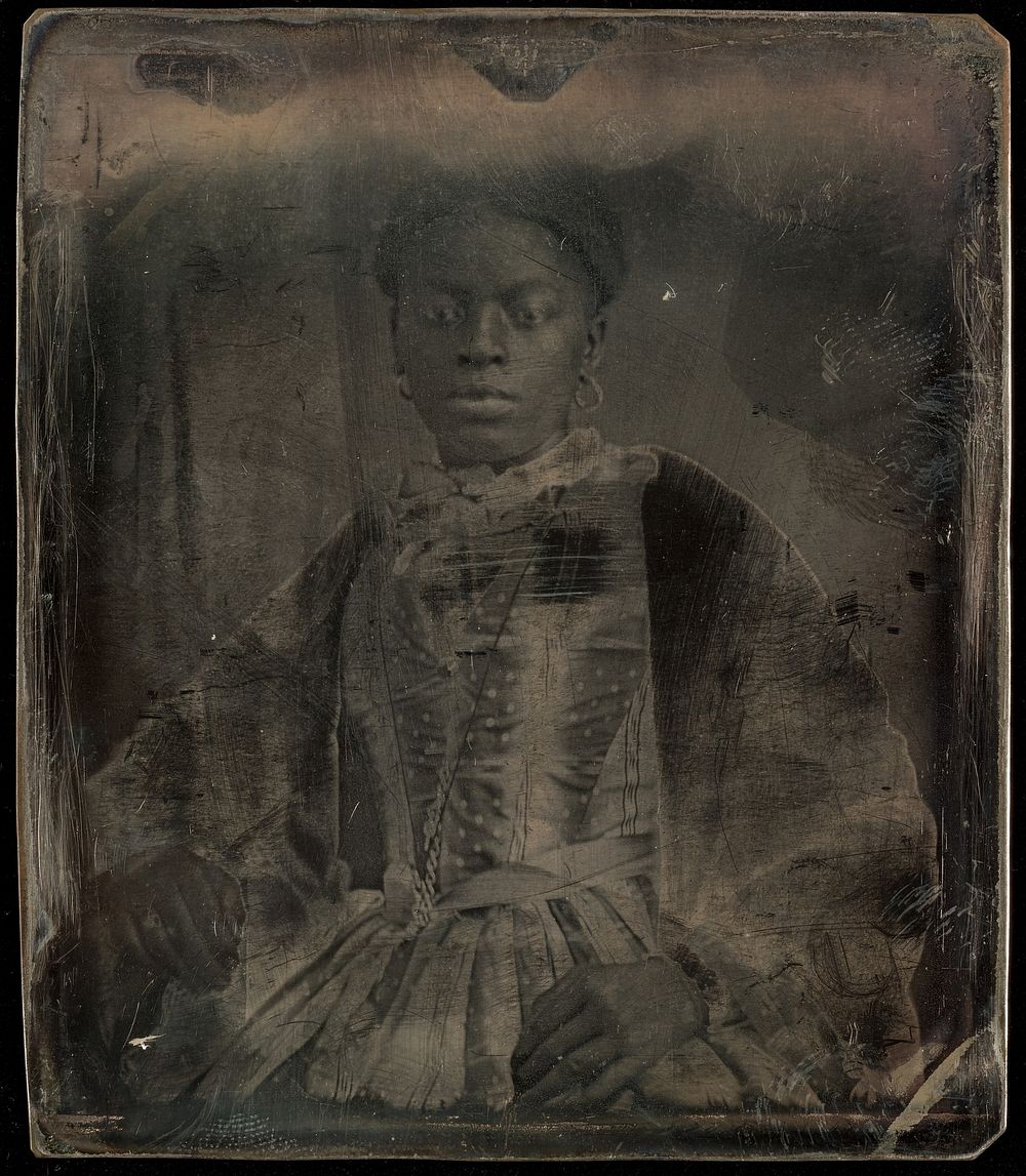 Portrait of a seated black woman in fancy dress