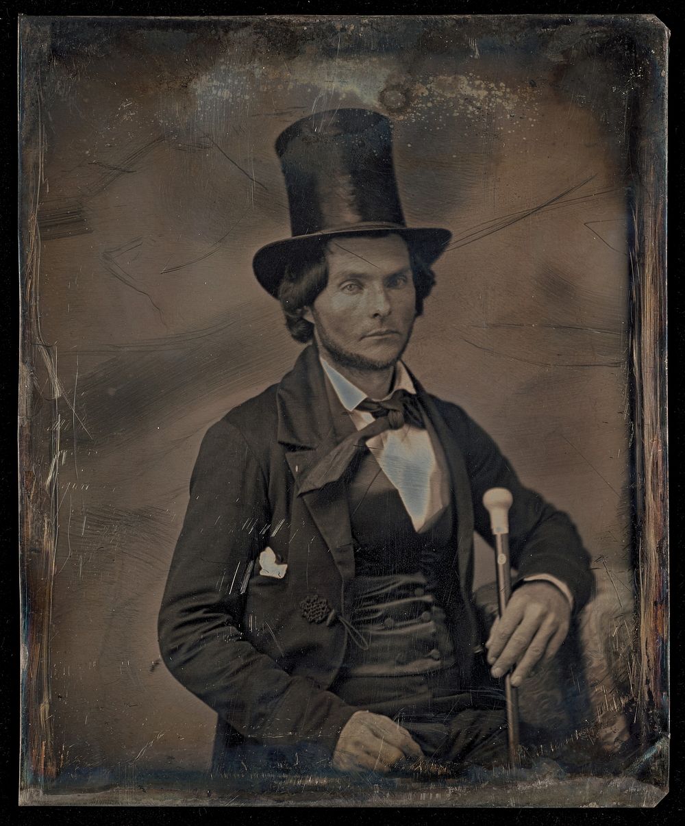 Portrait of a Seated Man with Chin Beard in Top Hat Holding Walking Stick