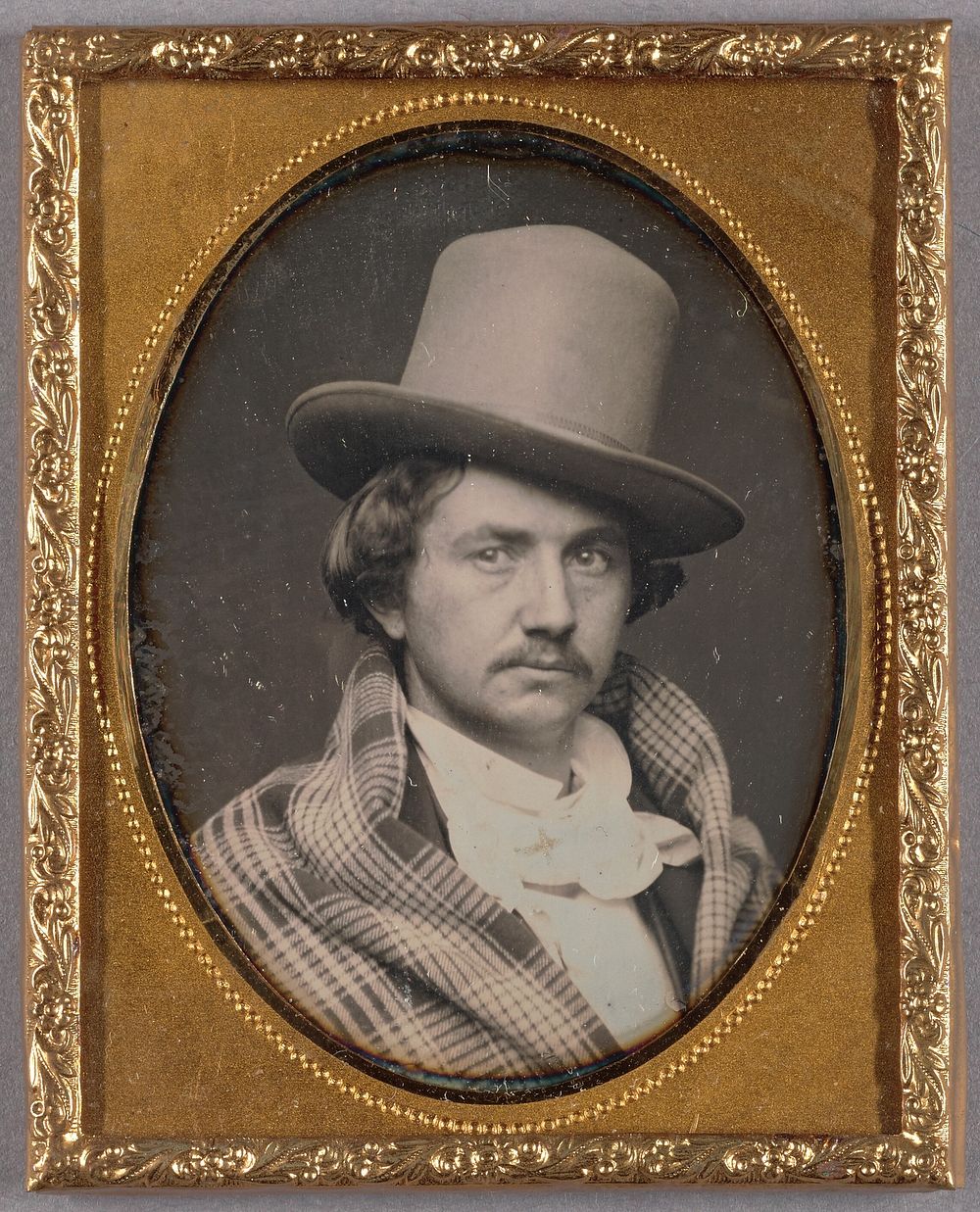 Portrait of a Moustachioed man wearing a large, tall hat