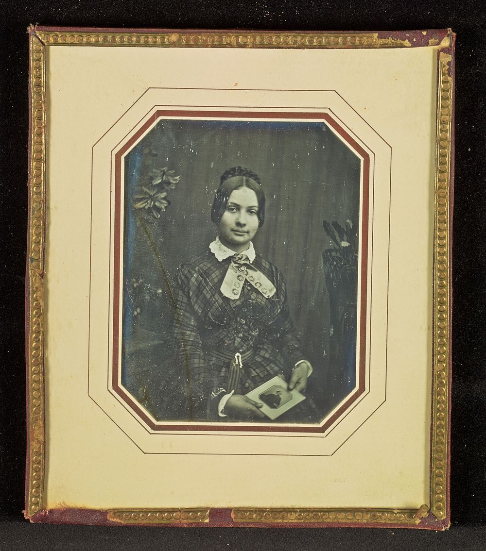 Portrait of a Woman Holding a Daguerreotype Portrait of a Man by Carl Ferdinand Stelzner
