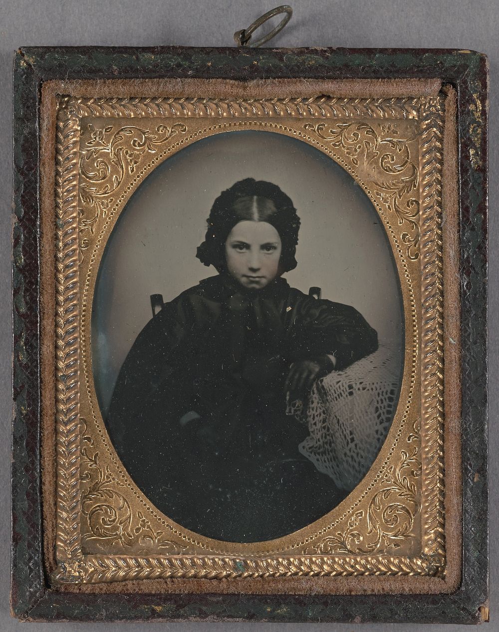 Portrait of a young girl dressed in dark clothes, wearing dark gloves