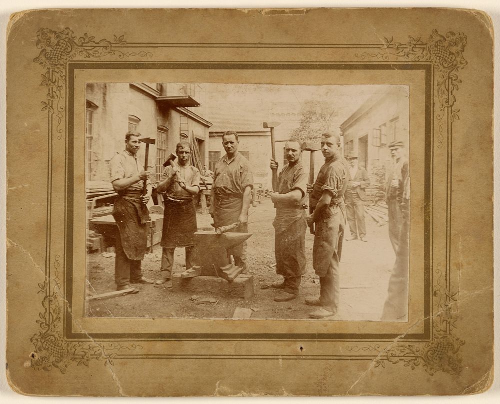 Five blacksmiths near an anvil, each holding a large hammer