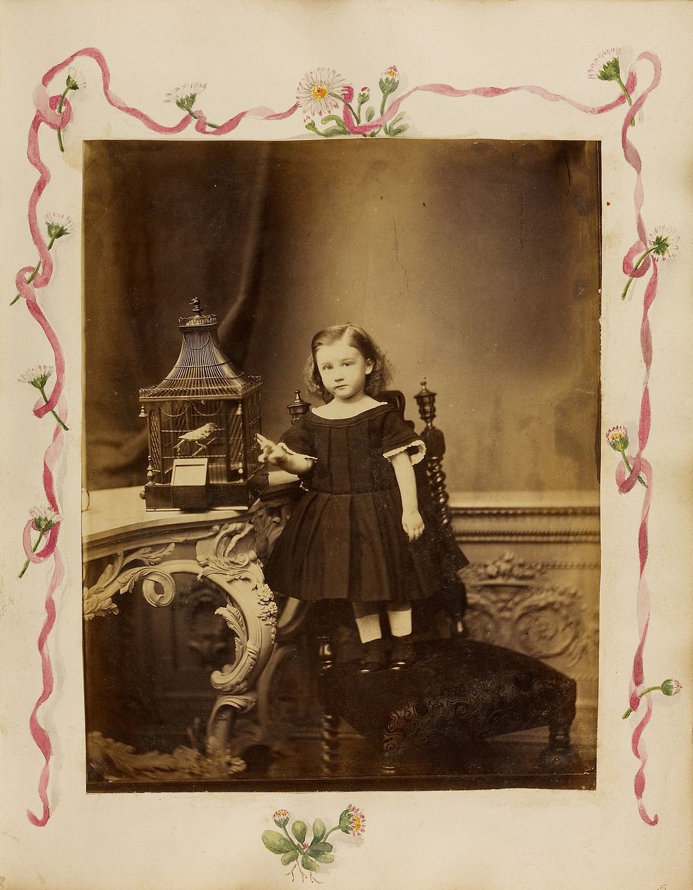 Portrait of young girl with bird cage