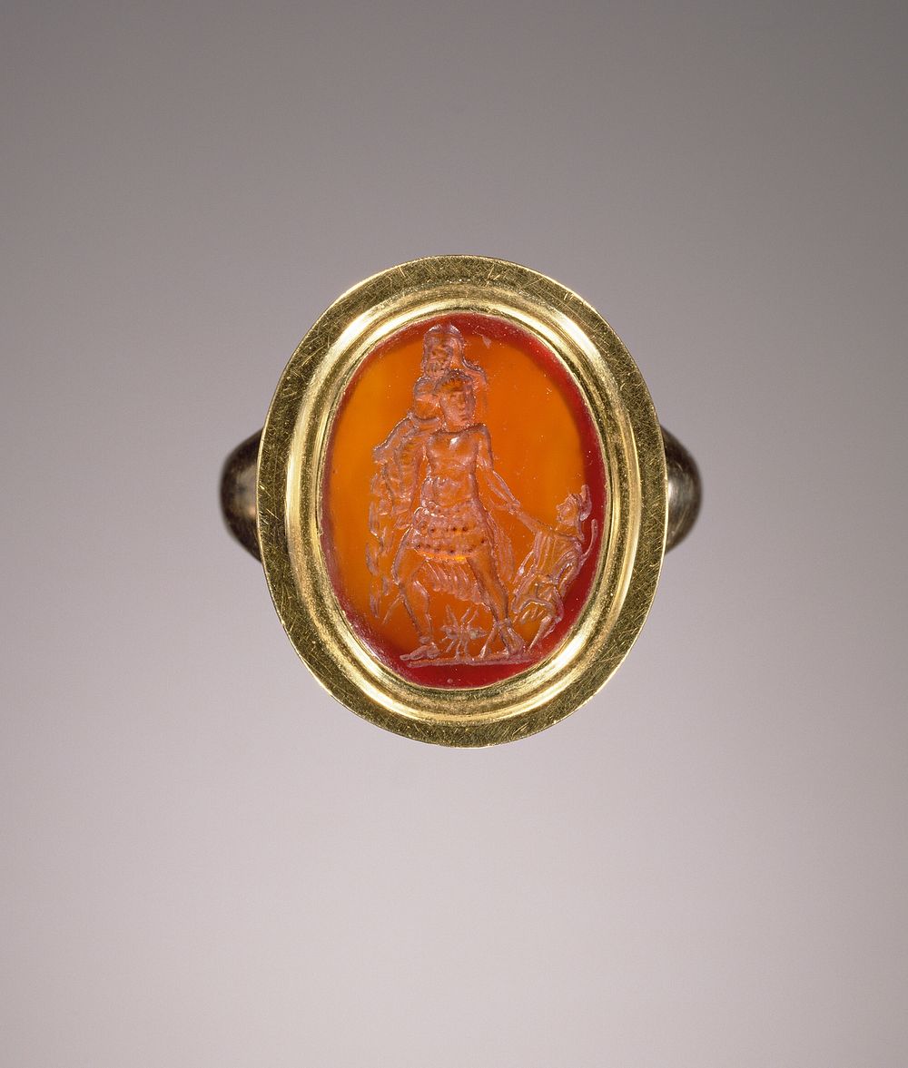 Engraved gem set in a modern ring