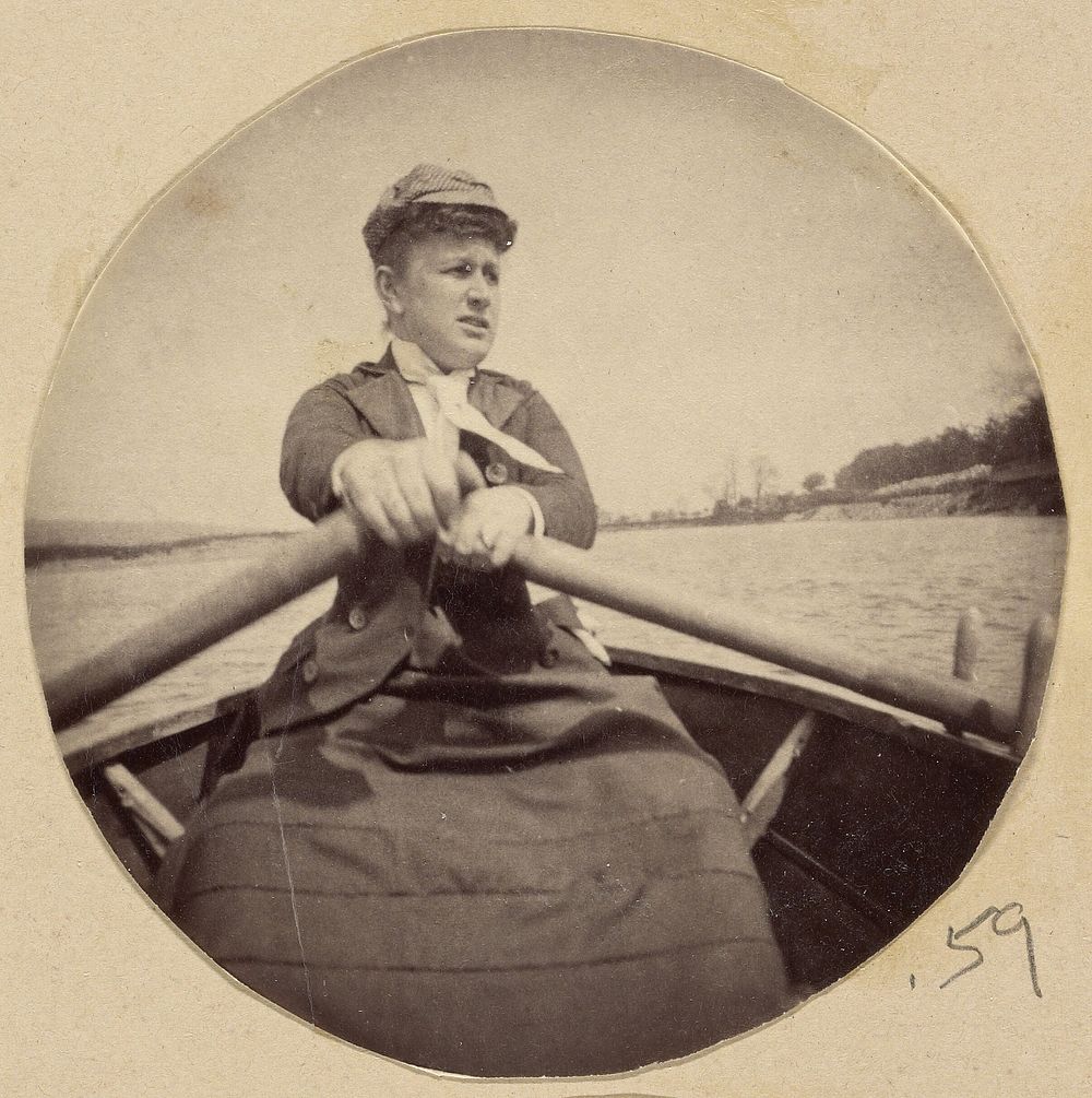 Woman in hat rowing a boat