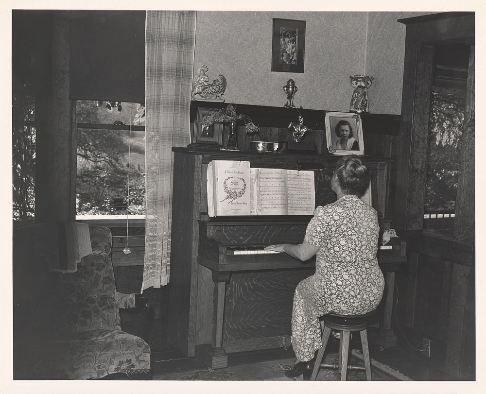 Fruit Farmer's Wife Playing Piano, Placer County, California by Russell Lee