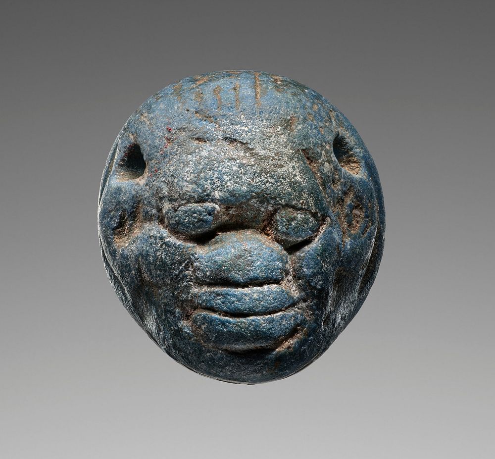 Seal in the form of a head, engraved with an animal combat