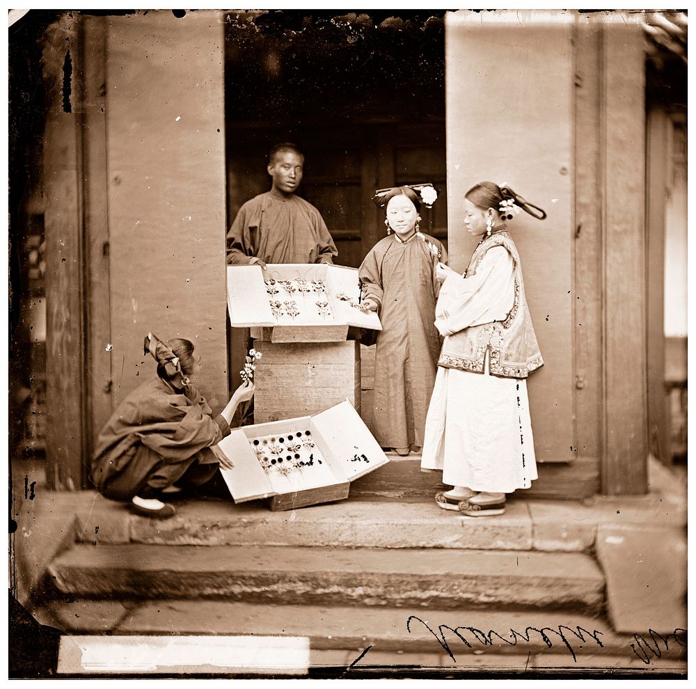 China: Manchu women buying flowers for their headdress, Beijing. Photograph by John Thomson, 1869.