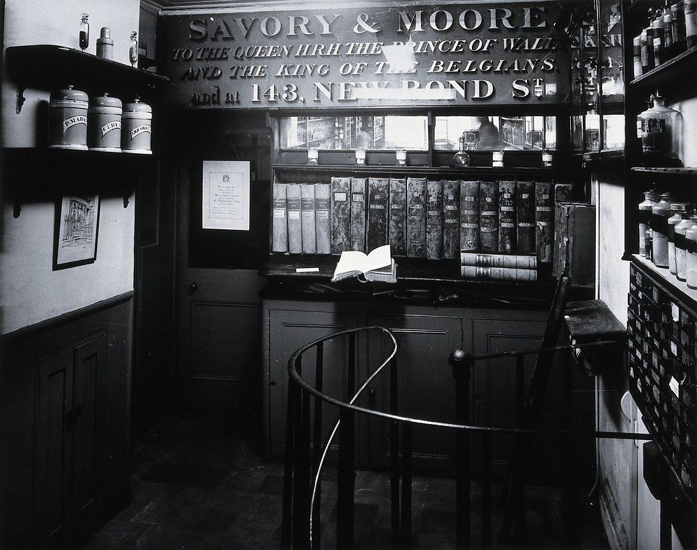 Savory & Moore Ltd: interior of the pharmacy; an upper floor which appears to be connected by a metal spiral staircase.…