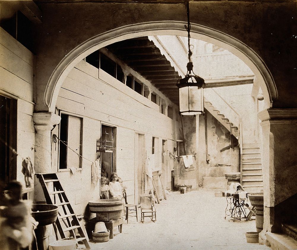 Tenement building, Cuba: an interior view of the entrance courtyard, with stairs to upper floors. Photograph, 1902.