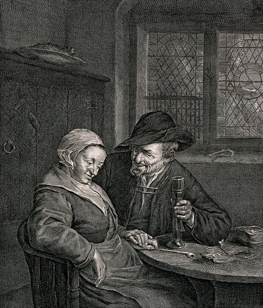 A couple sitting at a table: the man holds a glass in one hand, with the other he holds the woman's hand which is resting on…