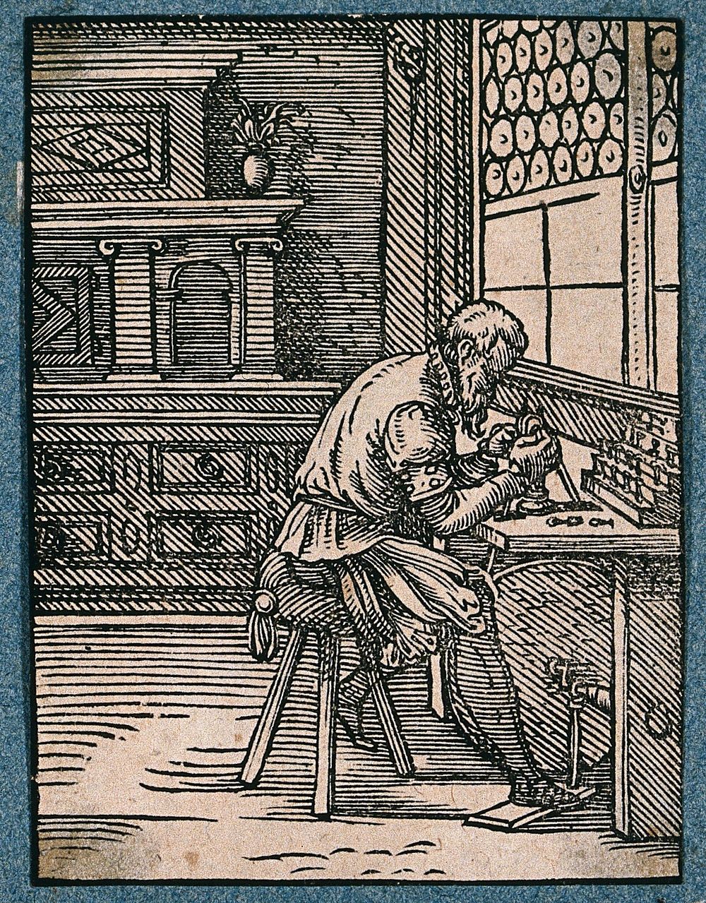 A man cutting gems using a treadle at his bench before a large window. Woodcut by J. Amman.
