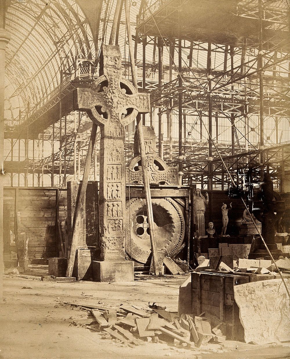 The Crystal Palace during its re-erection at Sydenham, London: a large celtic cross and other statues in the unfinished…
